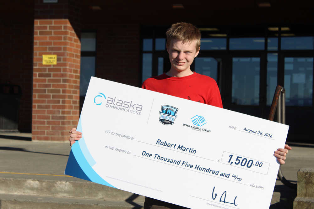 Homer High School senior Robert Martin shows off the $1,500 check he received as an awardee of the Summer of Heroes scholarship from ACS and Boys and Girls Club - Alaska. Martin wants to become an astronaut and attend Massachussets Institute of Technology (MIT) to study in a science, technology, engineering or mathematics (STEM) field - if he can swing more scholarships to make his dream possible.