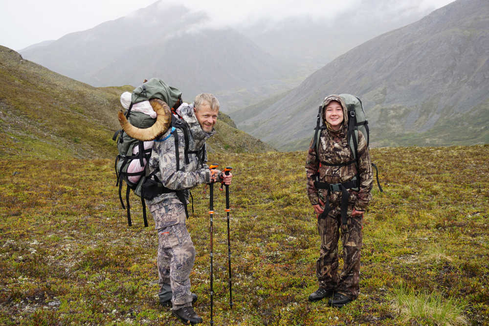 Doug and McKenzy Johnson hike back to camp with the Dall ram that McKenzy took down packed on their backs. McKenzy was able to shoot a Dall sheep on the Aug. 10 hunt and was the first person in her family to do so.