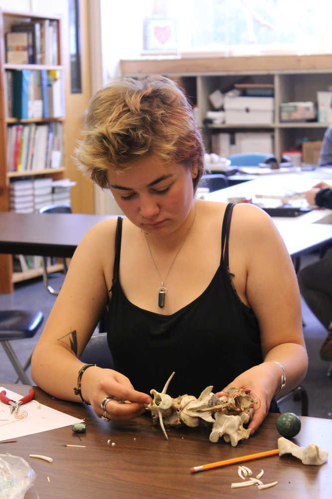 Cassidy Wylde uses bone to create a holder for a stone she values during the Sept. 9 Objects of Importance workshop at Homer Flex.