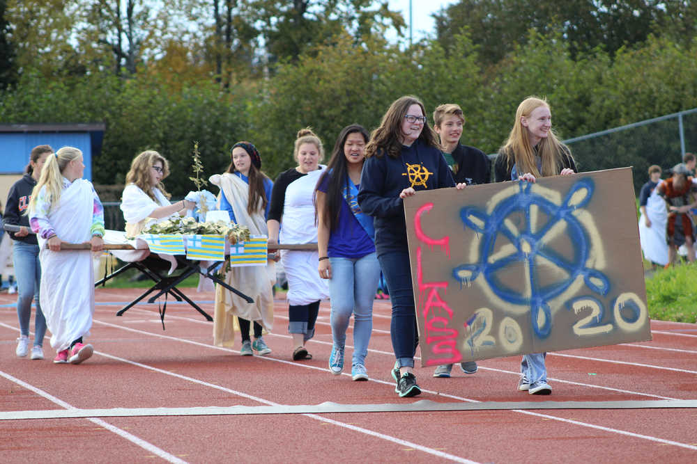 Homer High's freshman class carries their float during the Ancient Greece-themed Parade of Classes at halftime at the Saturday, Sept. 24 homecoming game.