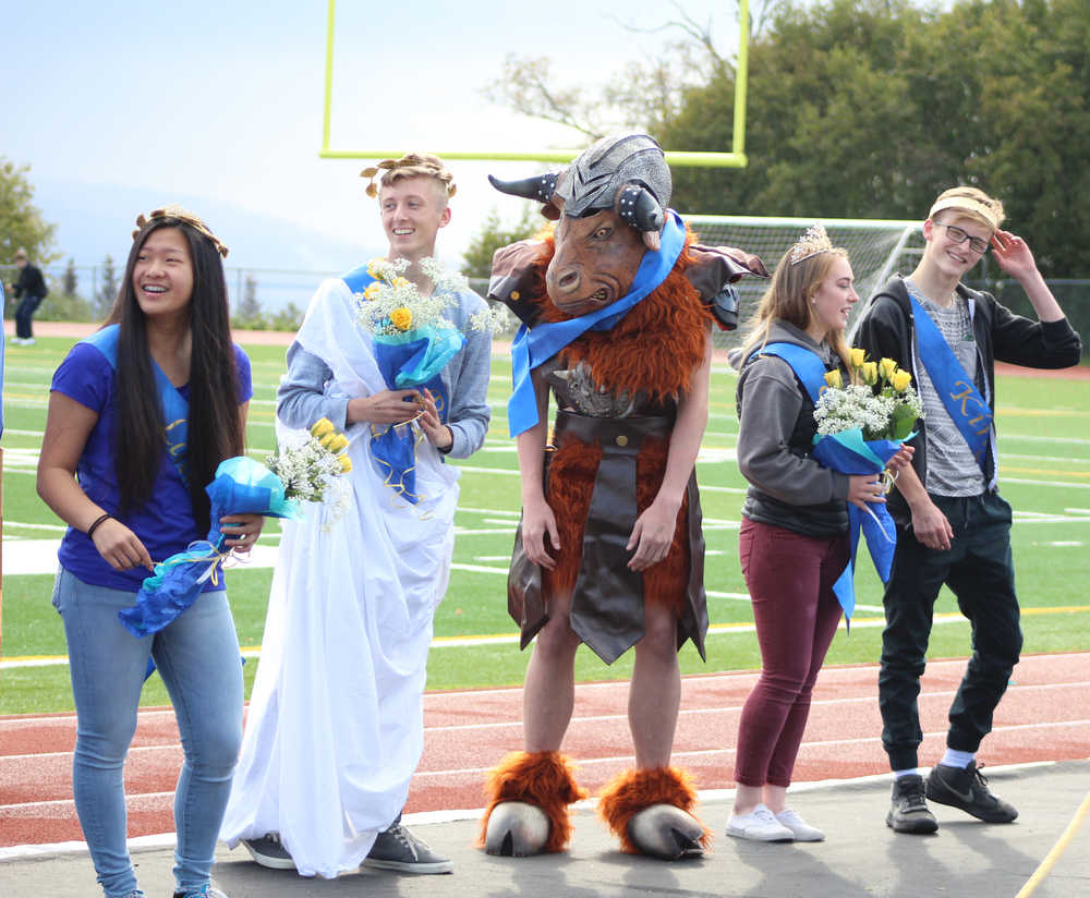 (left to right) Members of the 2016 Homer High School homecoming court Lady Abby Middleton; Prince Koby Etzwiler stands with a student dressed as the Ancient Greek monster, the minotaur, who stood in for absent Princess Maggie Box; and King Martin Welty and Queen Samantha Jacobsen pose for a photo at the homecoming game on Saturday, Sept. 24. The Parade of the Classes had a theme of Ancient Greece this year.