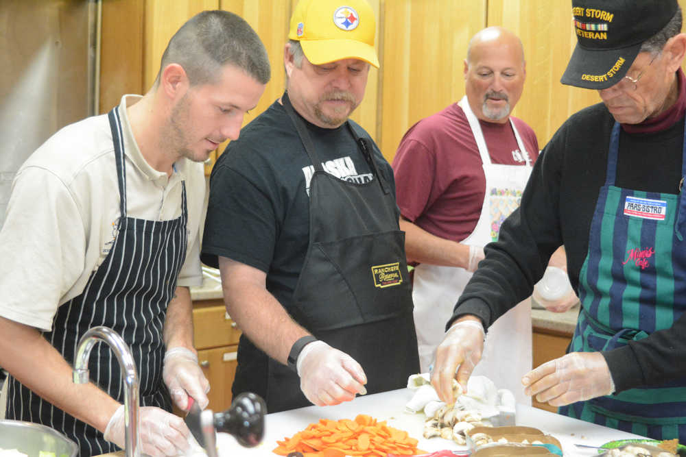 Rich Evanco, Ron Brahm, Tim Steinberg and Michael E. Gradney Jr. work in the kitchen at the Homer Food Pantry on Sept. 26 at Homer United Methodist Church.