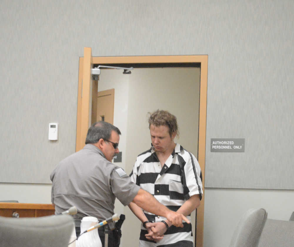 Homer Police Department Community Jail Officer Rick Pitta brings John Suter into the Homer District Courthouse for s his arraignment on Friday morning, Oct. 7.