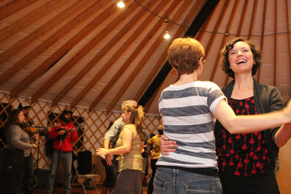 Jenifer Dickson dances with a partner during the Homer Folk School grand opening event on Saturday, Oct. 8.