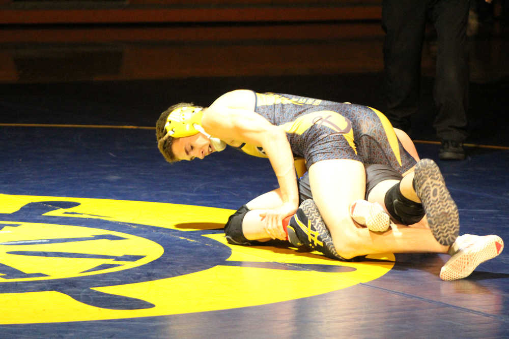 Jared Brant wrestles his opponent to the ground during senior night at Homer High School on Nov. 10.