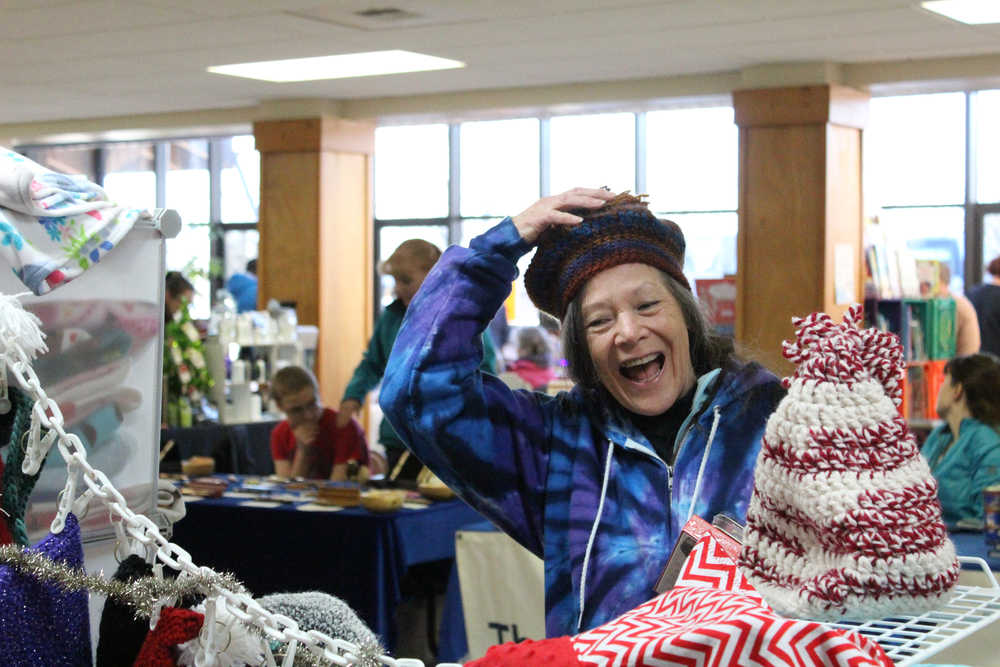 Linda Broahead tries on a hat made by Ardith Mumma at the Sugar Plum Faire on Dec. 10. The faire is an annual fundraiser for Homer Special Olympics.