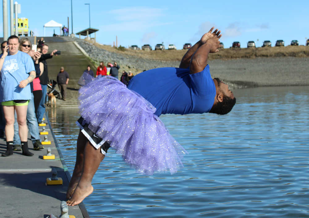 Randall White, co-event lead chairperson for Relay for Life in Homer, backflips into the 40 degree Homer harbor water. Eighteen people jumped into the water at the first Homer Halibut Plunge, raising $1300 for the American Cancer Society, White said. Those who missed out can join in on the frigid fun next year, as the group plans to make it an annual event.
