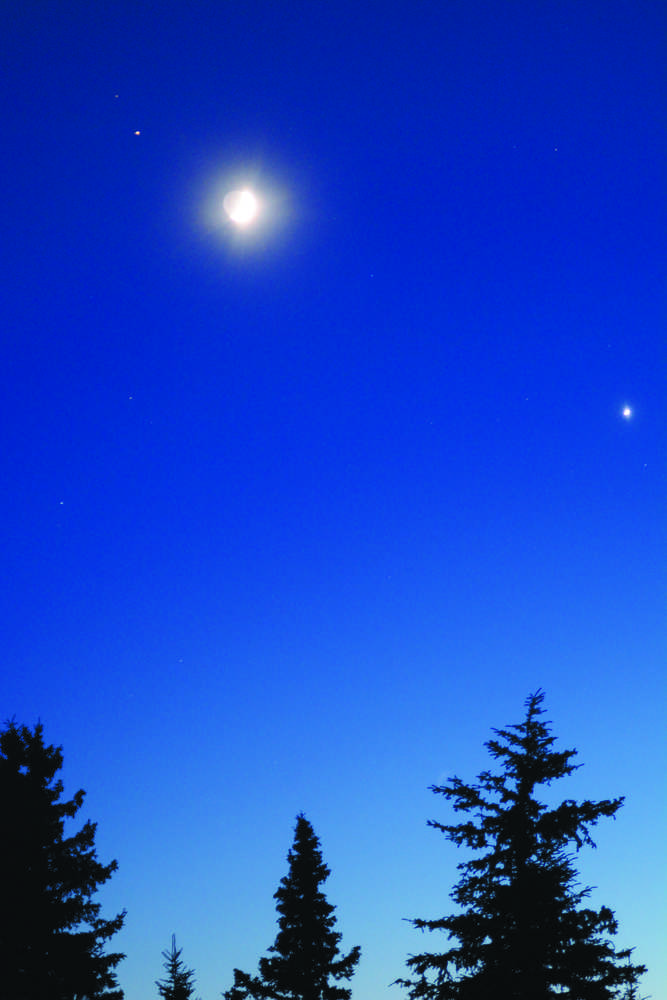 Mars, upper left, and Venus, lower right, flank the moon at sunset about 5:40 p.m. Monday, Jan. 2. On New Year's Day, Venus had been opposite the horns of the crescent moon and within 1.5 degrees.-Photo by Michael Armstrong, Homer News