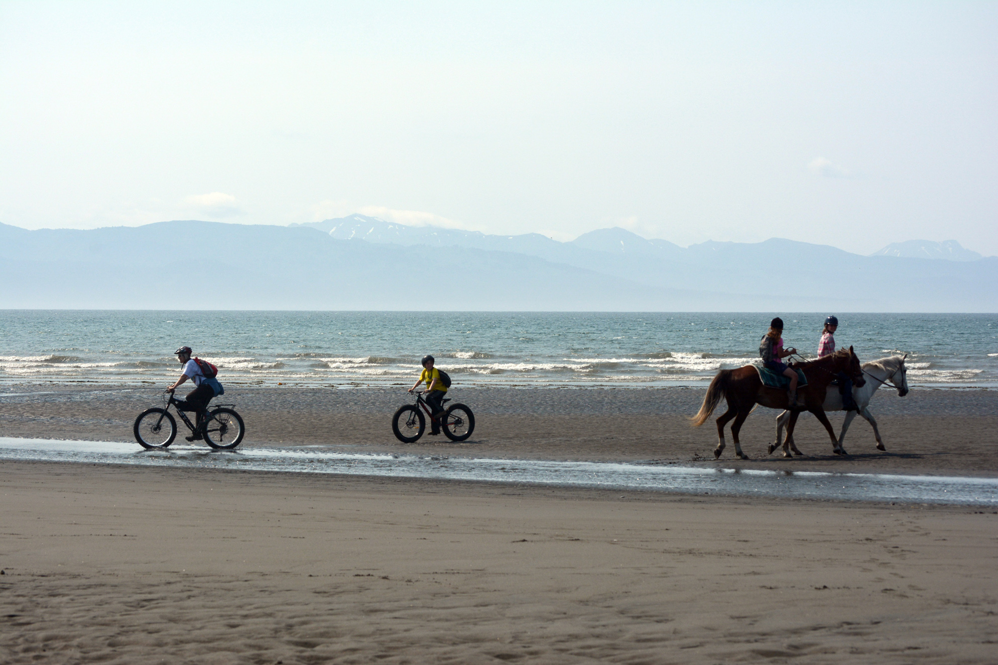 Bicyclists and horse riders pass each other near Mariner Park beach on the Homer Spit in late June. On Monday at its 6 p.m. regular meeting, the Homer City Council will go from placid tidepools to heavy surf when it considers an ordinance regulating motorized vehicle access to Bishop’s Beach and the Homer Spit. Horse riding and bike riding would not be restricted under recommendations by the Parks and Recreation Advisory Commission.-Photo by Michael Armstrong, Homer News