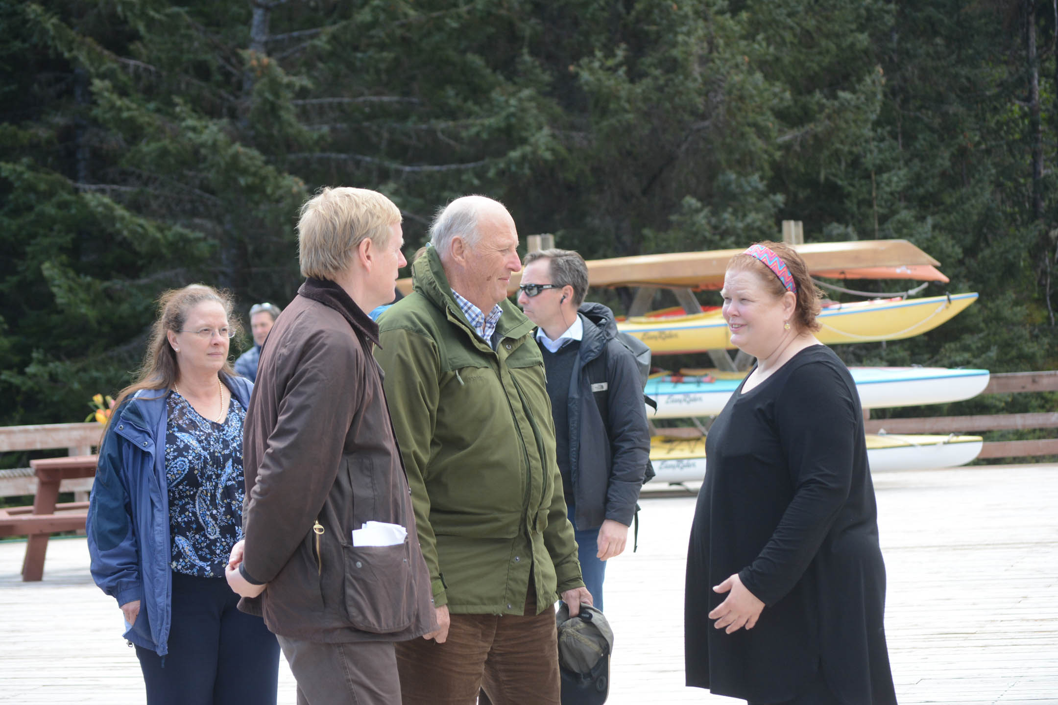 King Harald V, center, and  the Norwegian Ambassador to the United States, Kåre Aas, left, visit with Tutka Bay lodge owner Kirsten Dixon,  right, as Homer Mayor Beth Wythe, far left, watches.-Photo by Michael Armstrong; Homer News