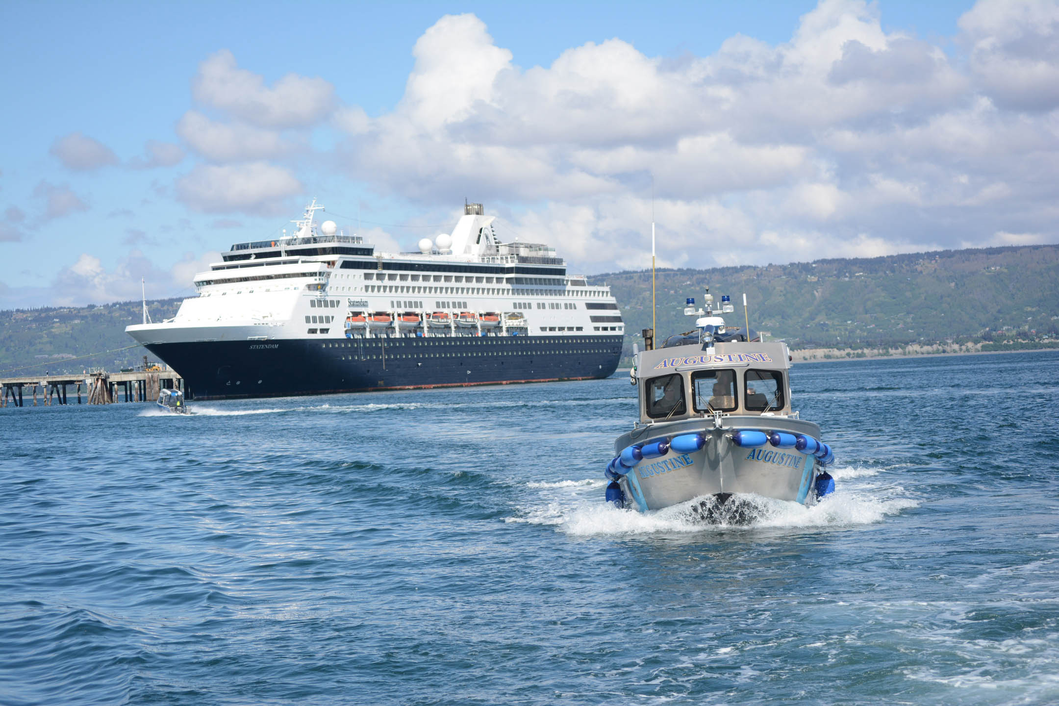 The P/V Augustine passes by the M/V Statendam as the Alaska Public Safety boat leaves the Homer Harbor on Tuesday. Troopers provided security for King Harald V on his visit to Homer.-Photo by Michael Armstrong; Homer News