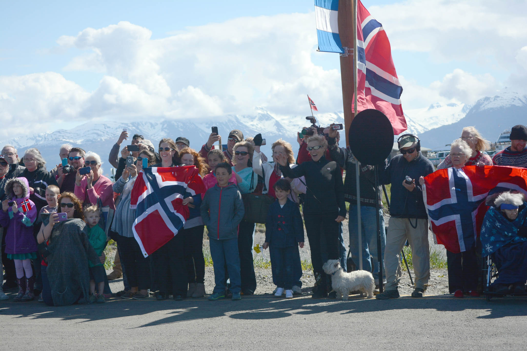 People wave and cheer for King Harald V as he arrives at the Homer Harbor on Tuesday.-Photo by Michael Armstrong; Homer News