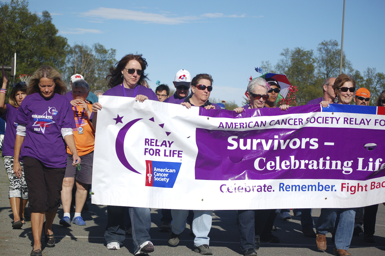 Cancer survivors start Relay for Life in 2013. The annual fundraiser starts at 6 p.m. Friday with the Survivors Walk at its new location of West Homer Elementary School. Closing ceremonies are at noon Saturday. Proceeds benefit American Cancer Society research and patient support programs.-Photo by Michael Armstrong, Homer News