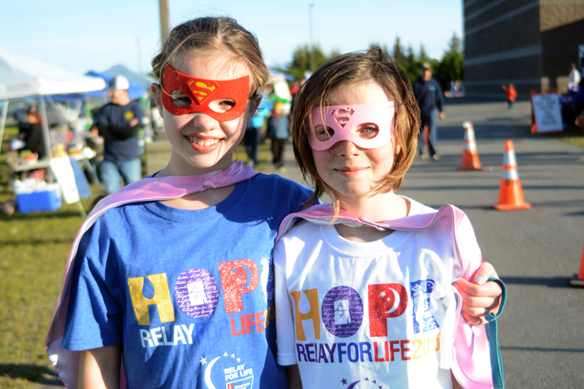 Sophia Park, left, and Neviya Reed of Team Puppies pause for a photo during Relay for Life last Friday at West Homer Elementary School.-Photo by Michael Armstrong, Homer News