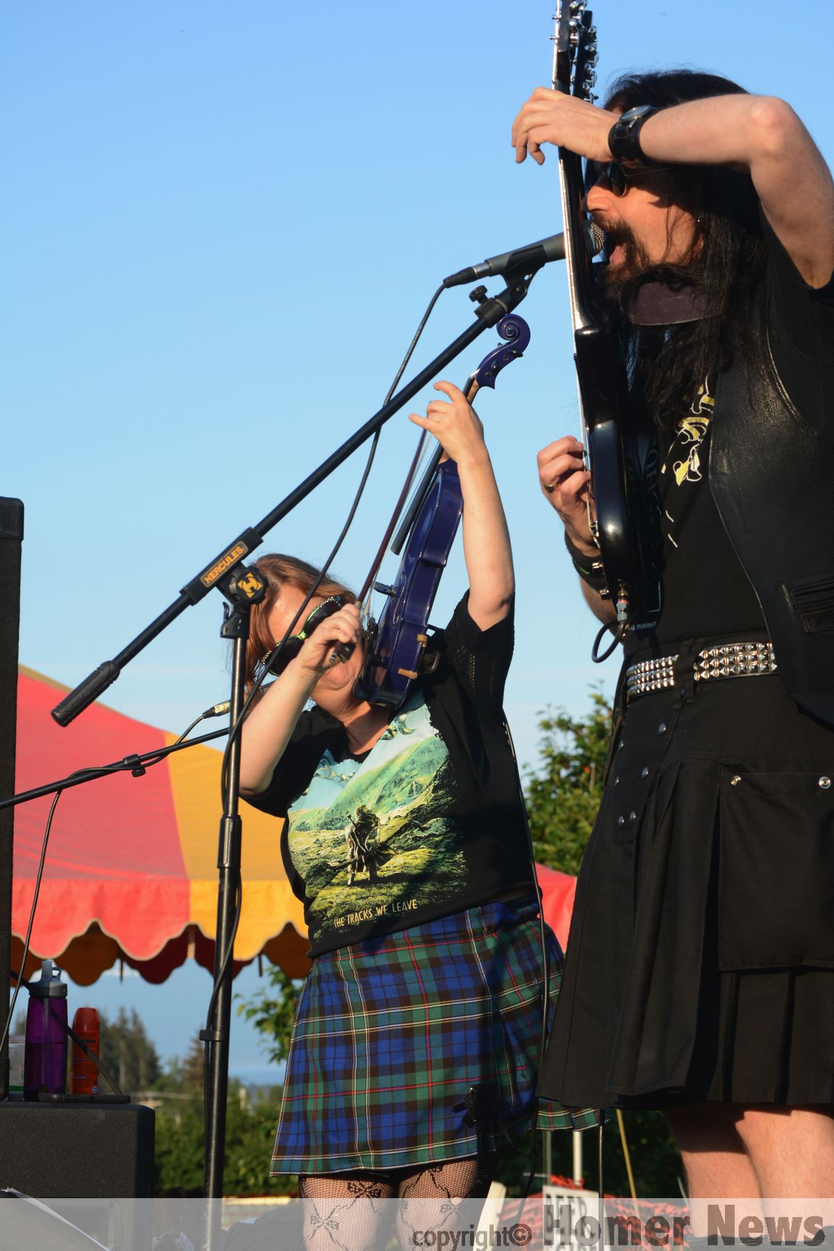 Kathy Buys, left, on fiddle, and Lief Sorbye, right, on mandolin, perform with Tempest last Friday at Karen Hornaday Park for the opening of CeltFest and the Highland Games. They played several songs based on Robert Burns poems. For photos and results of the games, see page 12.-Photo by Michael Armstrong, Homer News