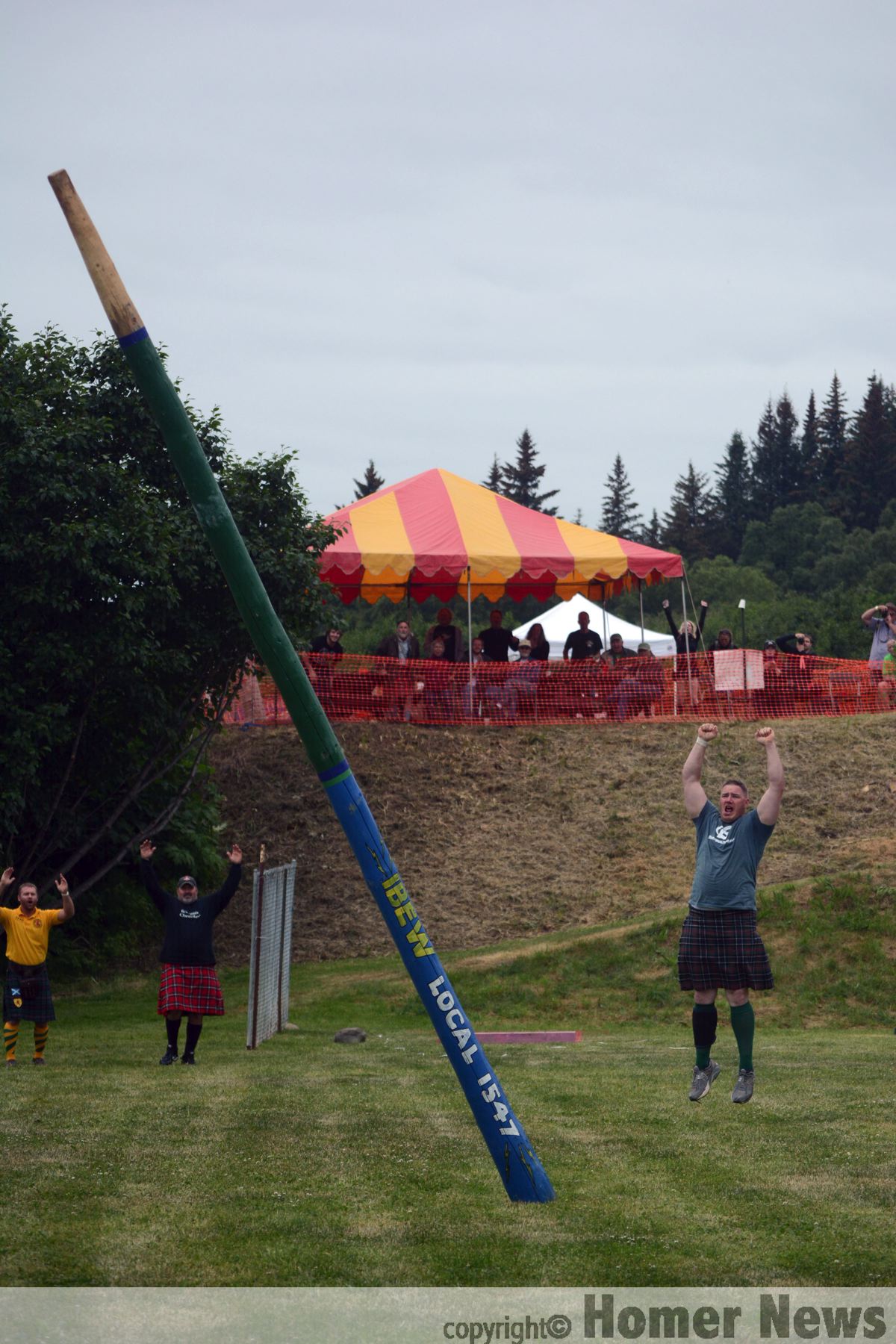 Matthew Patterson cheers as he flips the International Brotherhood of Electrical Works Local 1547 challenge caber — the first athlete in the history of the Kachemak Bay Celtic Club Highland Games to do so.