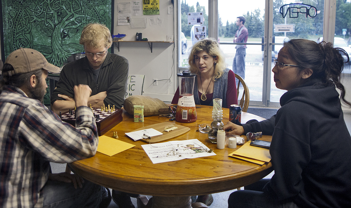From left, Logan Jensen of Homer, Homer Olson of Homer, Caitlin Tebo of Anchorage and Gale Kakaruk of Kenai enjoy socializing and a game of chess on Saturday at the Green Rush Events Clubhouse in Kenai. The clubhouse, which operates on a members-only policy, allows residents to share and use cannabis in the absence of state or local regulations.-Photo by Megan Pacer, Morris News Service - Alaska