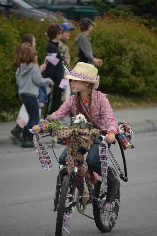 Emily Grimm, Alaska cowgirl, rides her decorated bike.-Photo by Michael Armstrong