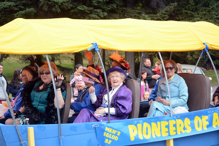 Members of the Pioneers of Alaska ride their float.-Photo by Michael Armstrong