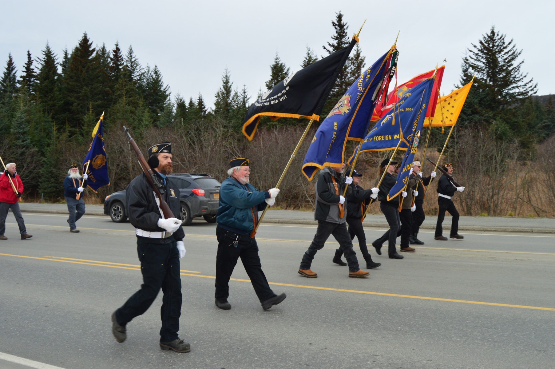 Members of the Veterans of Foreign Affairs, Anchor Point Post, and the American Legion Post 16 march in a Veterans Day parade today on the Sterling Highway. Homer honored veterans with a parade and a ceremony at the Veterans Memorial at the Alaska Islands and Ocean Visitor Center.-Photo by Annie Rosenthal, Homer News