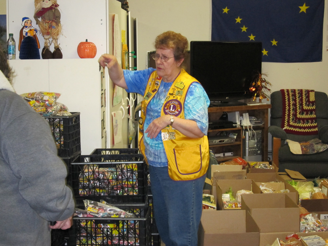 Kachemak Bay Lions Club member Fran Van Sandt, who has coordinated the club’s Thanksgiving Basket program for more than 25 years, directs the orchestra of volunteers it takes to pack baskets back in 2010. Volunteers are needed to help with this year’s basket packing beginning at 8:30 a.m. Saturday at Homer United Methodist Church.-Homer News file photo