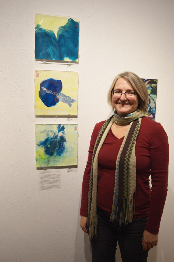 Sharlene Cline shows off a set of three prints of her body parts at the opening of Bunnell Street Art Center’s 10x10 show on Nov. 20. A second opening for the general public will be held on Dec. 4.