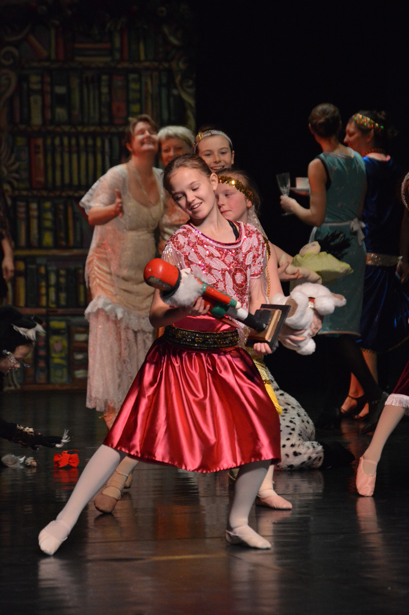 Aiyana Cline as Clara admires her new nutcracker in the ballet’s opening scene.-Photo by Annie Rosenthal