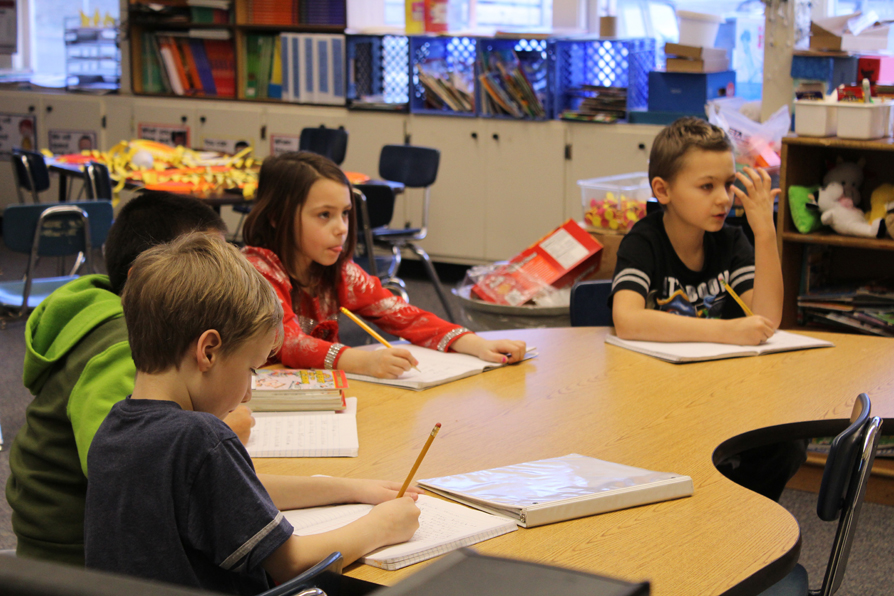 Students Aiden Crane, Lynnzi Stout, Alex Shae and Quinton Blaine concentrate on a lesson in Jasmine Woodhead’s first and second grade class at Chapman School.-Photo by Anna Frost, Homer News
