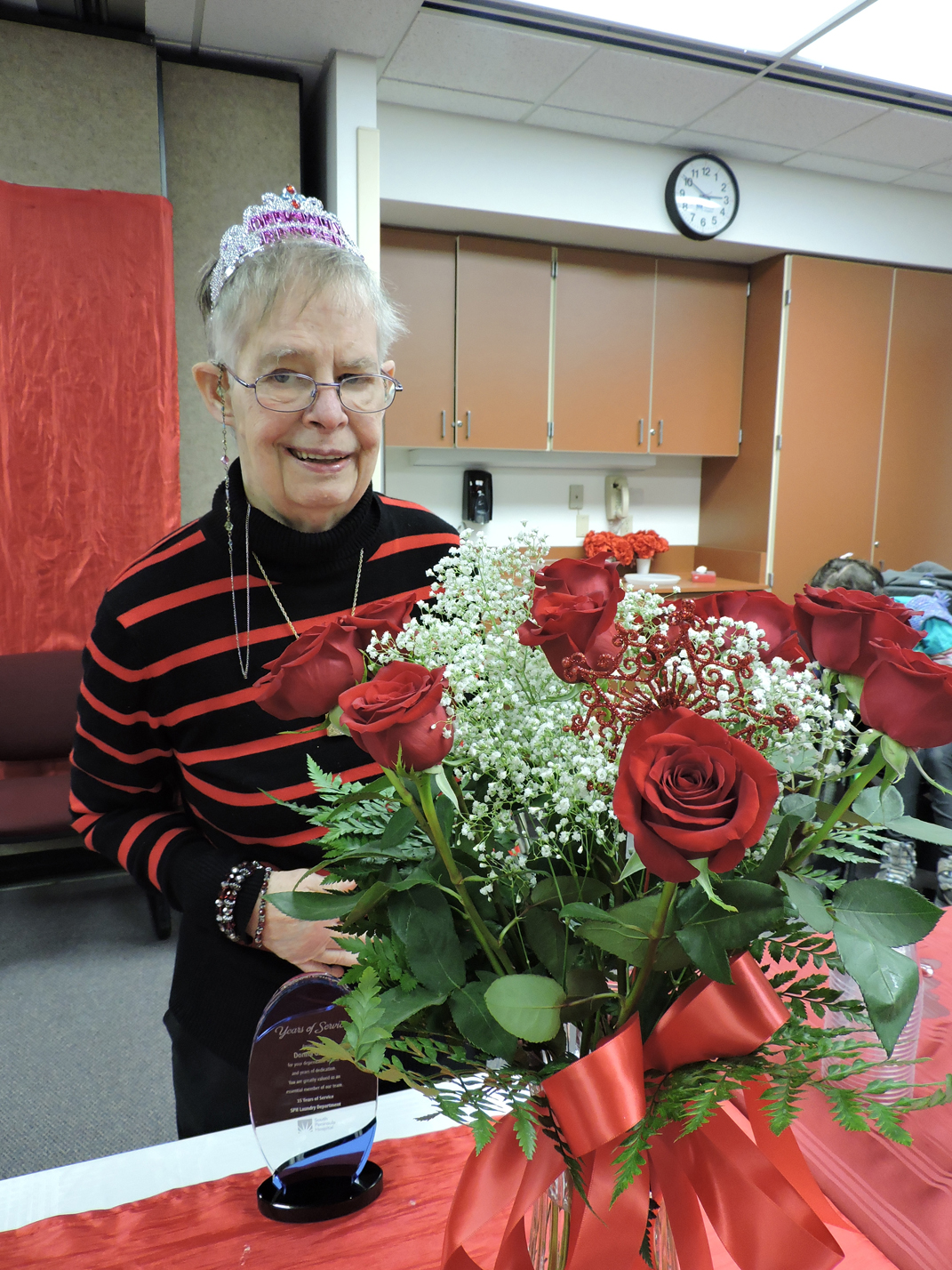 South Peninsula Hospital employee Donna Glover is honored during a retirement celebration in her honor Jan. 12. She received a bouquet of roses and a trophy recognizing her 35 years of service. Other gifts included a six-year subscription to the Homer News.  -Photo provided