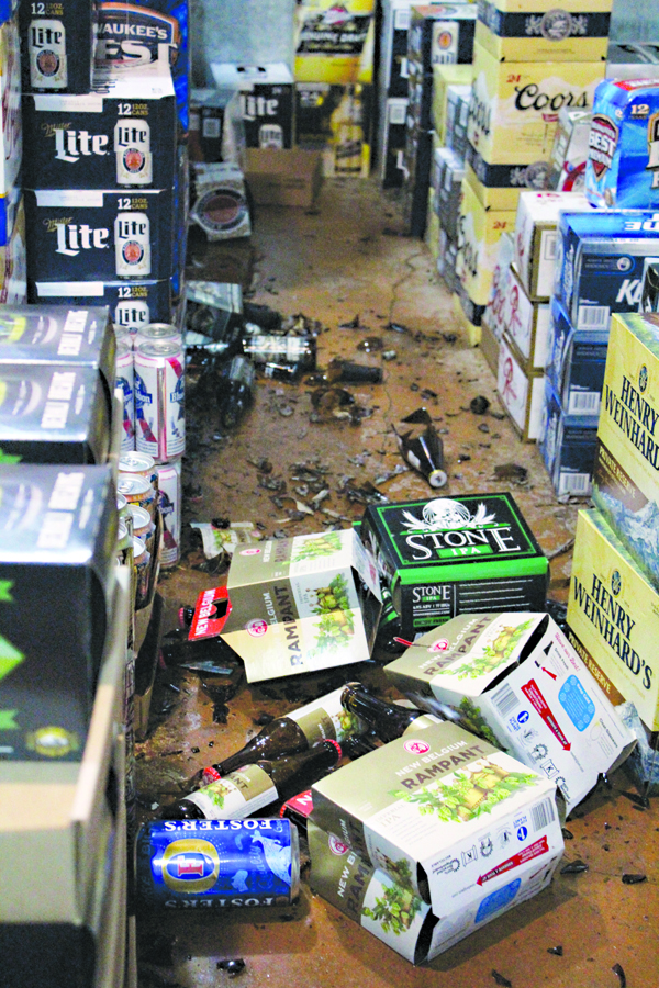 Cans and bottles of beer litter the floor at the East End Grog Shop after Sunday’s 7.1 magnitude earthquake. -Photo by Anna Frost, Homer News