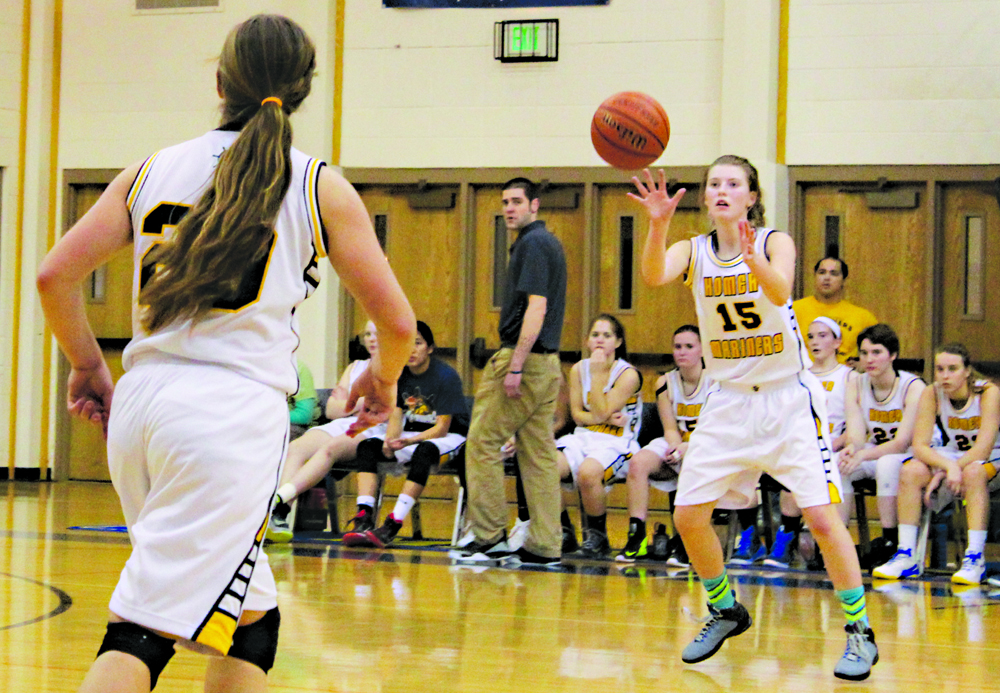 Mariner sophomore Alissa Cole catches a pass from teammate Aurora Waclawski during the Friday, Jan. 22, home game against Nikiski. The Mariner girls came out on top by 10 points, their second victory in two weeks against Nikiski.-Photo by Anna Frost, Homer News