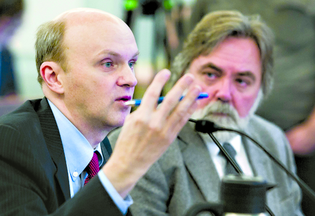 John Tichotsky, chief economist, left, and Randall Hoffbeck, Commissioner for the Department of Revenue, give a revenue forecast presentation to the Senate Finance Committee on Monday.-Photo by Michael Penn, Morris News Service - Alaska