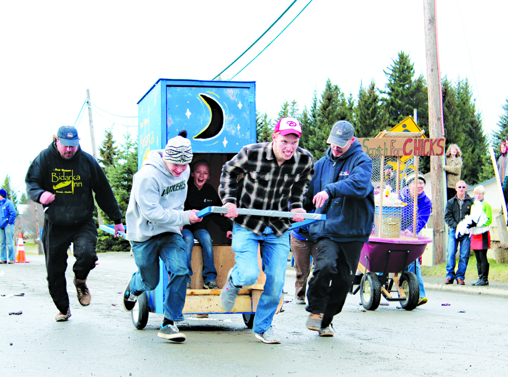 The Bidarka Inn team runs up Pioneer Avenue in the Homer Winter Carnival outhouse races. The Northern Enterprises team won the race.-Photo by Anna Frost, Homer News