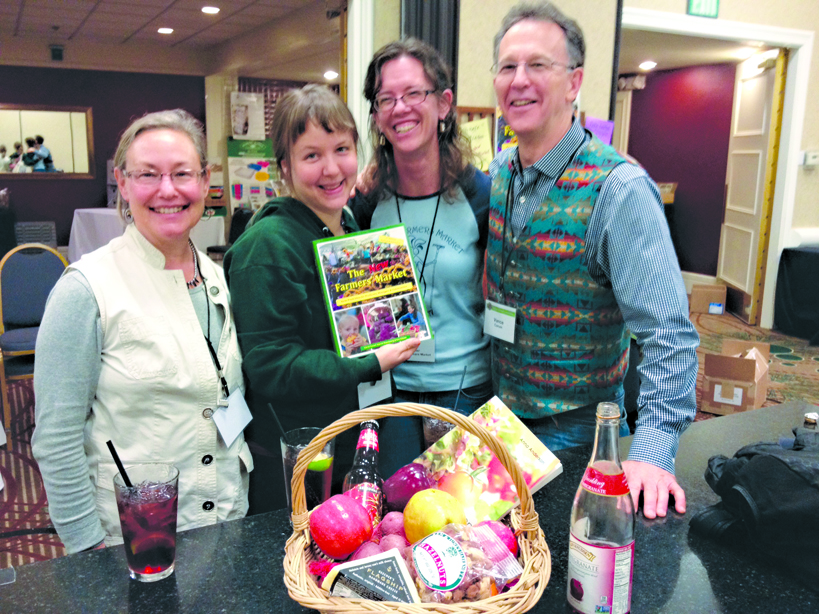 Homer Farmers Market board member Lori Jenkins, manager Robbi Mixon and avid market supporter Kyra Wagner meet Van Corum, author of “The New Farmers Market,” at the Washington State Farmers Market Association Conference in February when Mixon won a prize package that included the new second edition of the book.-Photo provided