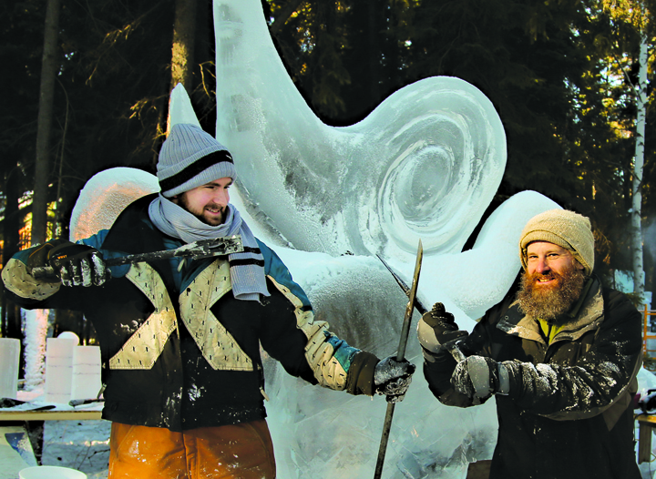 Barnabas Firth, left, and Ben Firth, right, pose in front of their first-place ice sculpture-Photo by Karen H. Clautice