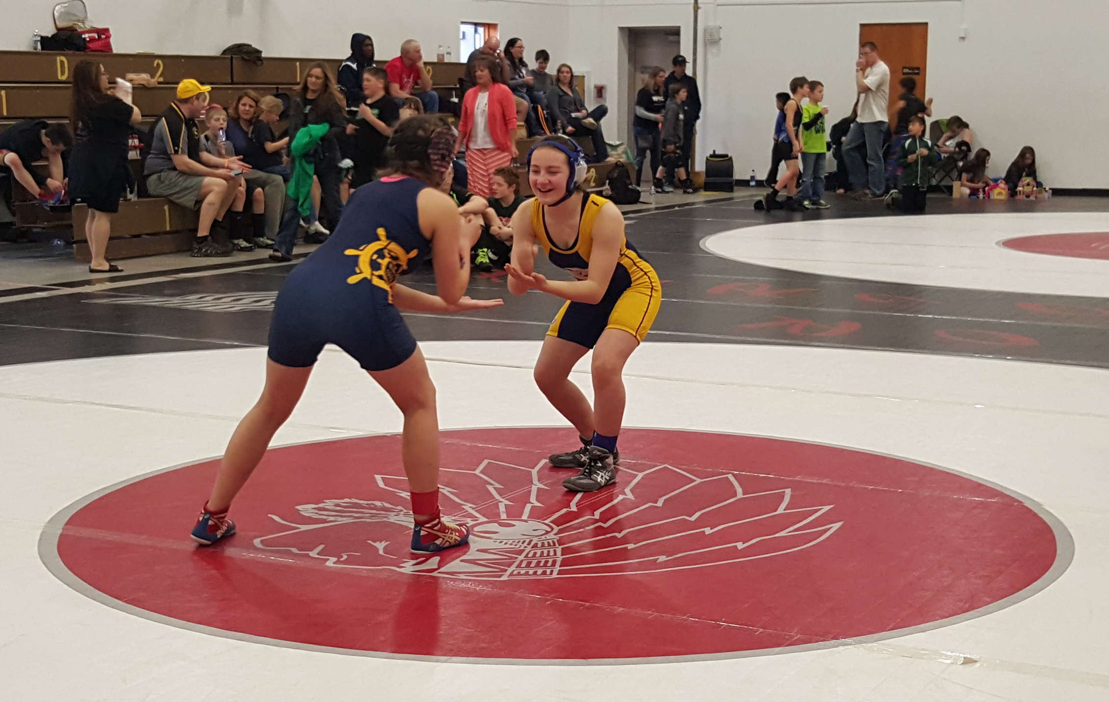 Mina Cavasos, an eighth grader in her fourth year of wrestling, competes with Popeye wrestler and friend Sadie Blake, a seventh grader in her first year of wrestling. Mina won for first place in the Arctic Warriors girls division  and Sadie placed second.-Photo provided