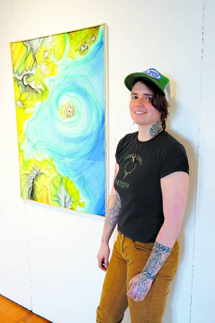 Sarah Frary, who uses the name Sarah Tonin in her art, stands by one of her paintings for “Lyrical Topography” at Bunnell Street Arts Center.-Photo by Michael Armstrong, Homer News