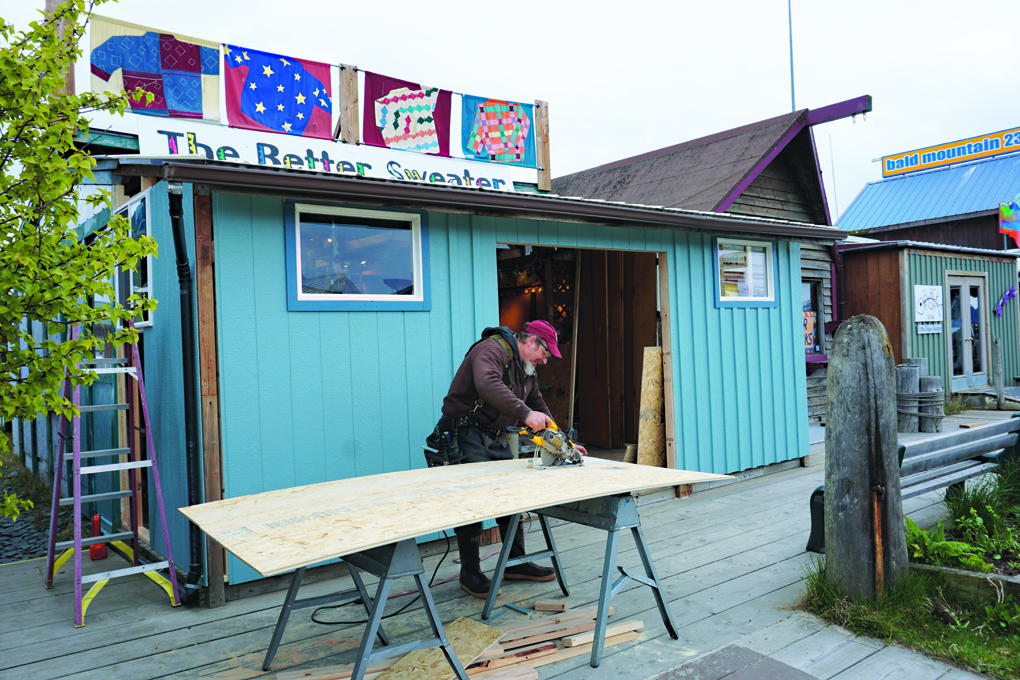 Carpenter Scott Speaker works on an addition to The Better Sweater on the Homer Spit last Friday. Better Sweater owner Indira Mukambetova said her shop will open for Memorial Day.