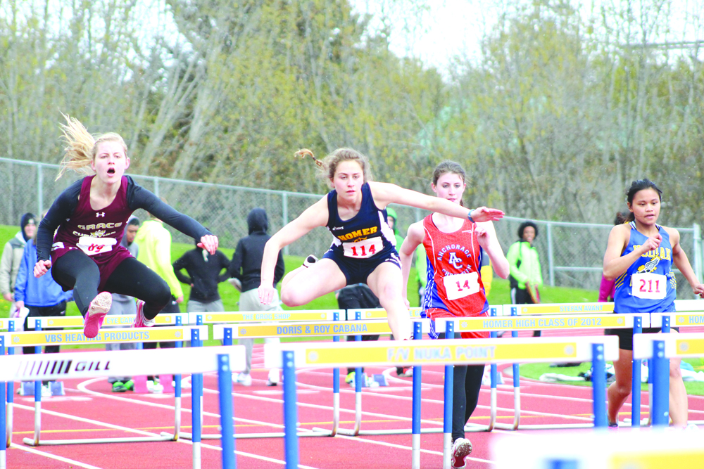 Lauren Evarts clears a hurdle during the Homer Invite pentathlon 100-meter hurdle event. Evarts placed first in the hurdle event and second overall in the pentathlon.-Photo by Anna Frost, Homer News