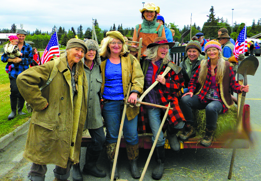 (left to right) Wurtilla H. Hepp, Fay Graham, Catkin Kilcher Burton, Stellavera Kilcher, Mossy Kilcher, Cindy Middleton, and Sunrise Sjueberg pose for a photo on their float in the 2015 Fourth of July float. -Photo by Karen Howorth.