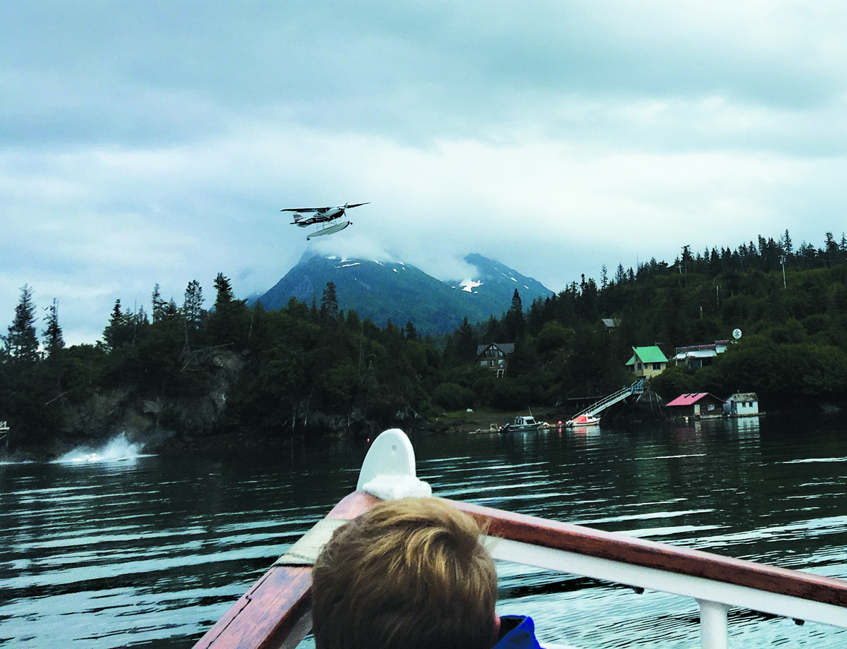 A photo taken by Dolores Wilber, a visitor from Chicago, shows Alice Rogoff's Cessna 206 as its starboard float falls into the water. The float appears to have come loose after the plane clipped a tree. Wilber took the photo from the Danny J.-Photo by Dolores Wilber