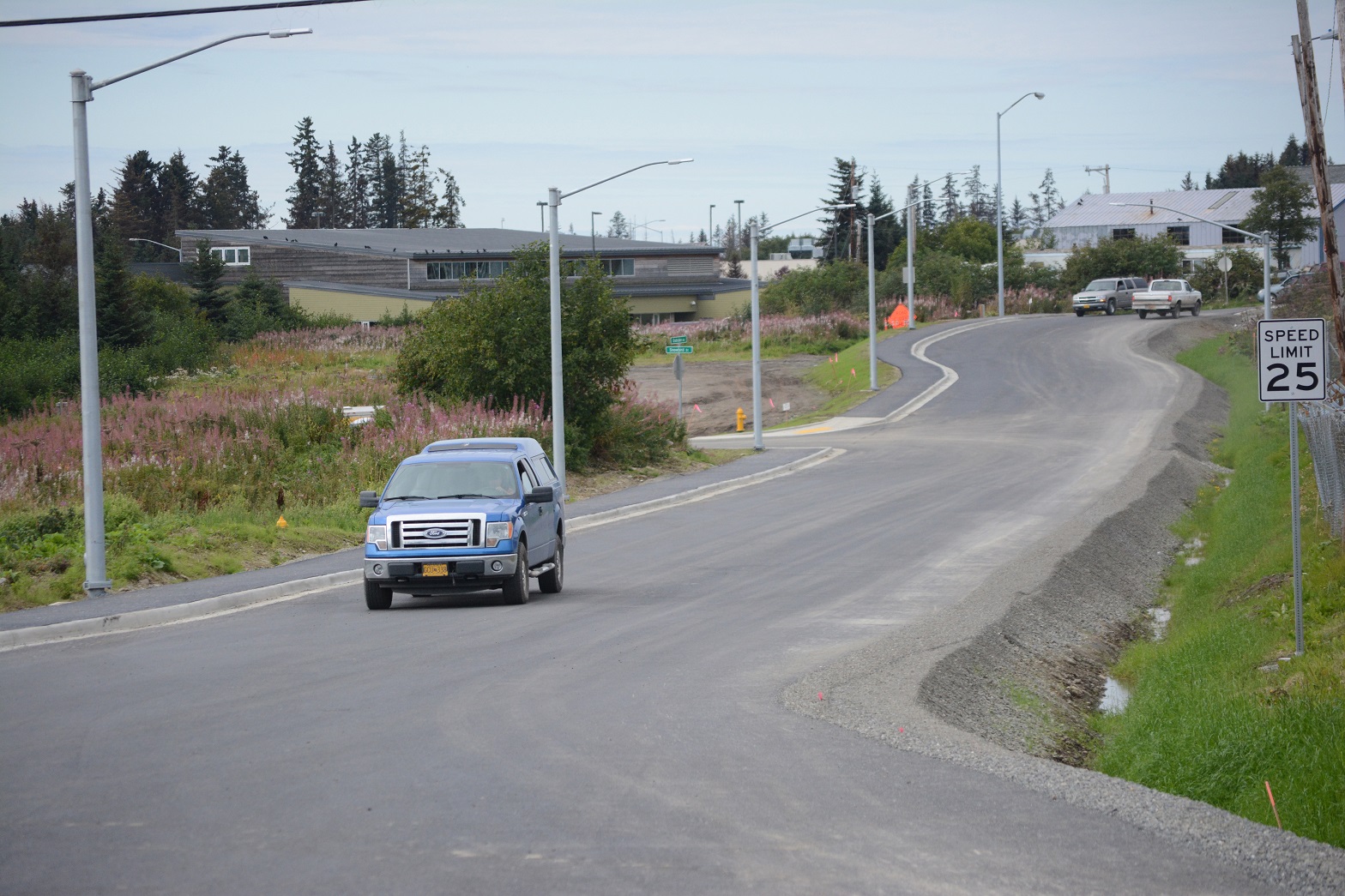 Cars move down a new extension of Grubstake Avenue and Snowbird Street on Aug. 16. Grubstake now connects Heath Street and Lake Street and Snowbird Street - formerly Waddell Way - connects Grubstake Avenue to the Homer Post Office and the Sterling Highway.-Photo by Michael Armstrong, Homer News