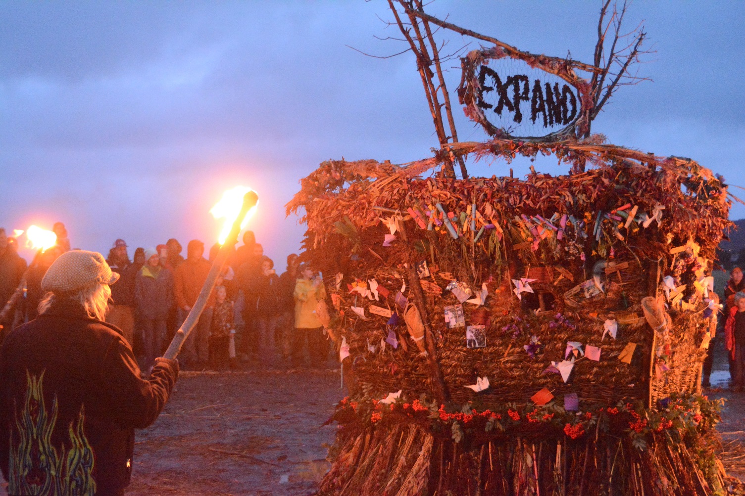 Mavis Muller, left, prepares to ignite this year's Burning Basket, Expand, on Sunday night at Mariner Park on the Spit.