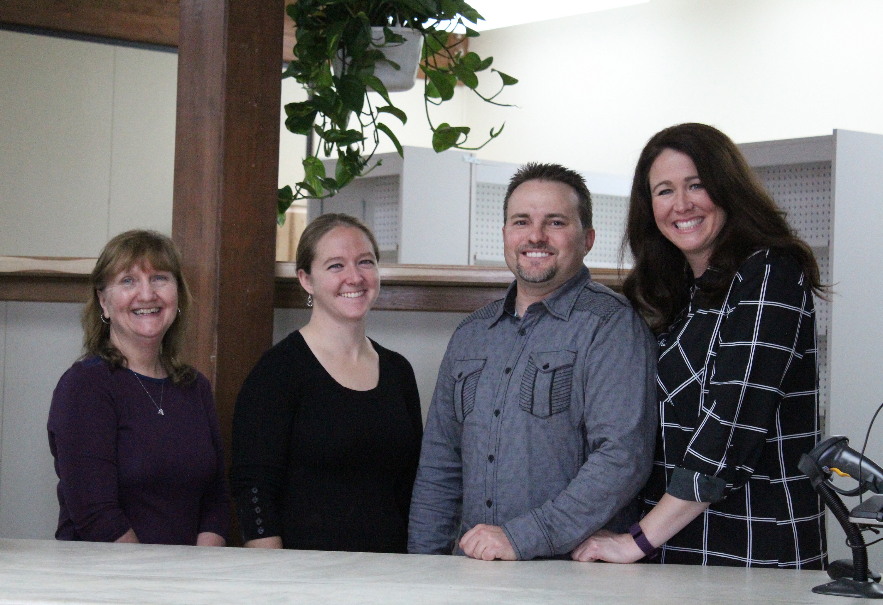 From left, Scotts Family Pharmacy technicians Diane Glanville and Krista Glanville and owners Nathan and Gina Scott pose for a photo at the pharmacy counter window. The pharmacy opened for business on Wednesday, Oct. 5.