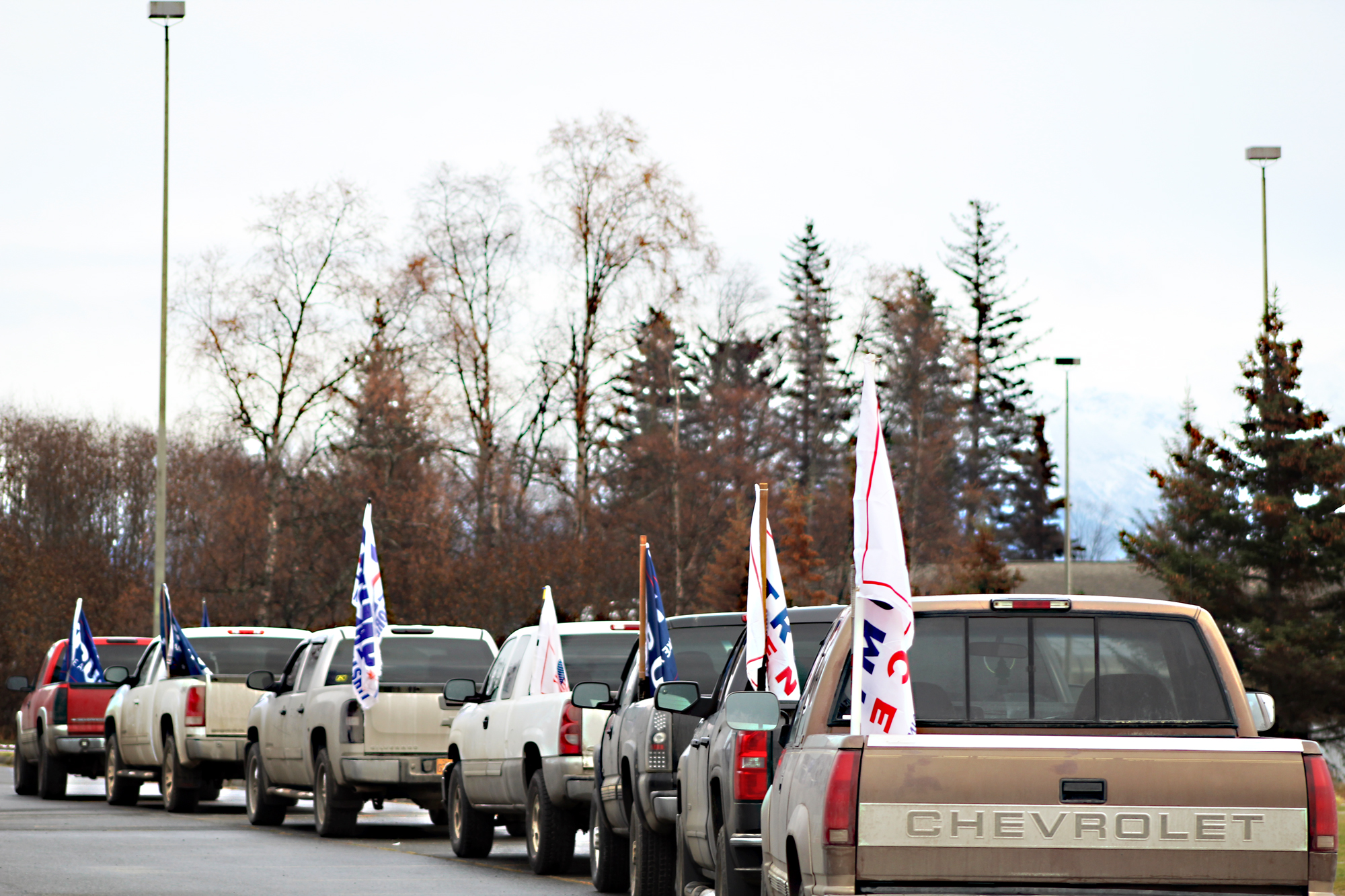 A line of pickup trucks sport Trump-Pence flags in the Homer High School parking lot on Election Day, Nov. 8.