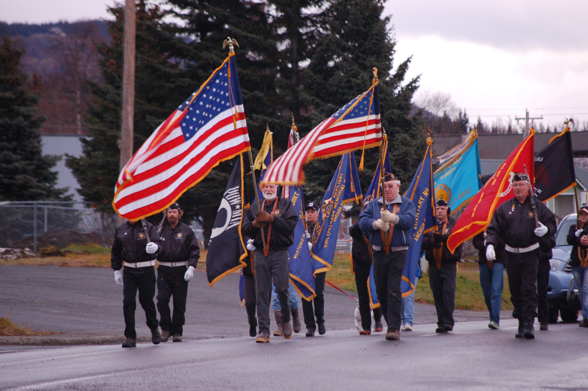 Veterans march on Pioneer Avenue in a recent Veterans Day parade.-Homer News File Photo