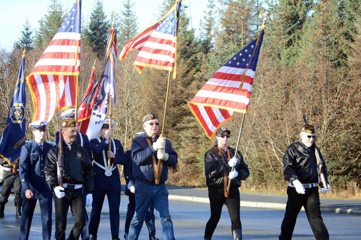 Members of the Anchor Point VFW Post and the U.S. Coast Guard march in the Veterans Day parade on the Sterling Highway.