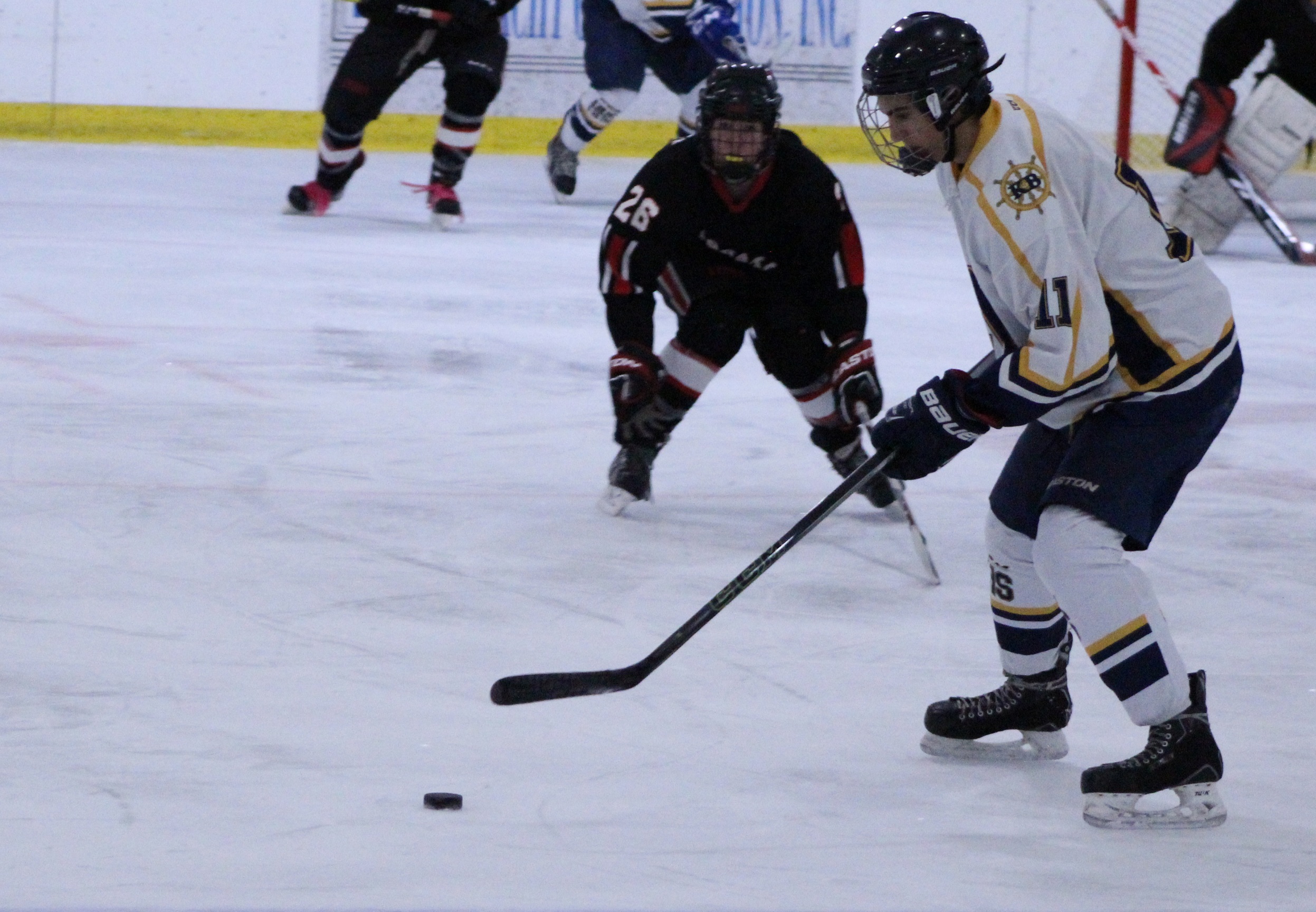 Mariner Charlie Menke sweeps in to take the puck away from a Houston player during their game on Thursday, Nov. 17 at the End of the Road Shootout at Kevin Bell Arena.-Photo by Anna Frost, Homer News