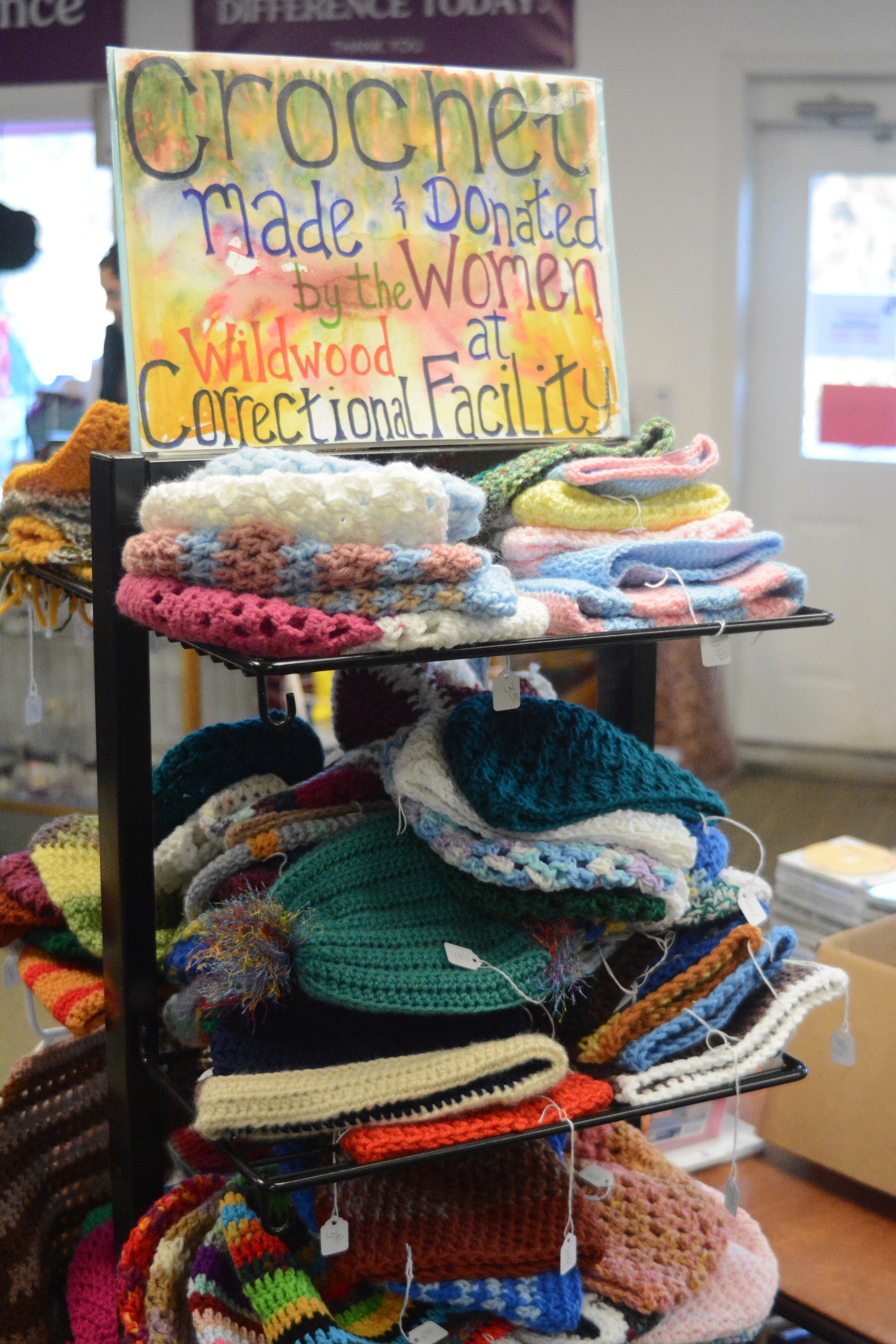 Crocheted items are featured for sale at Homer thrift on Ocean Drive in Homer. HOmer Thrift and others donated yarn to women at the Wildwood Correctional Pretrial Facility for them to crochet hats, scarves, sweaters and other items. The women have donated their handicraft for sale at Homer Thrift, with proceeds benefiting the Child Advocacy  Centers of South Peninsula Haven House in Homer and Kenai.-Photo by Michael Armstrong, Homer News