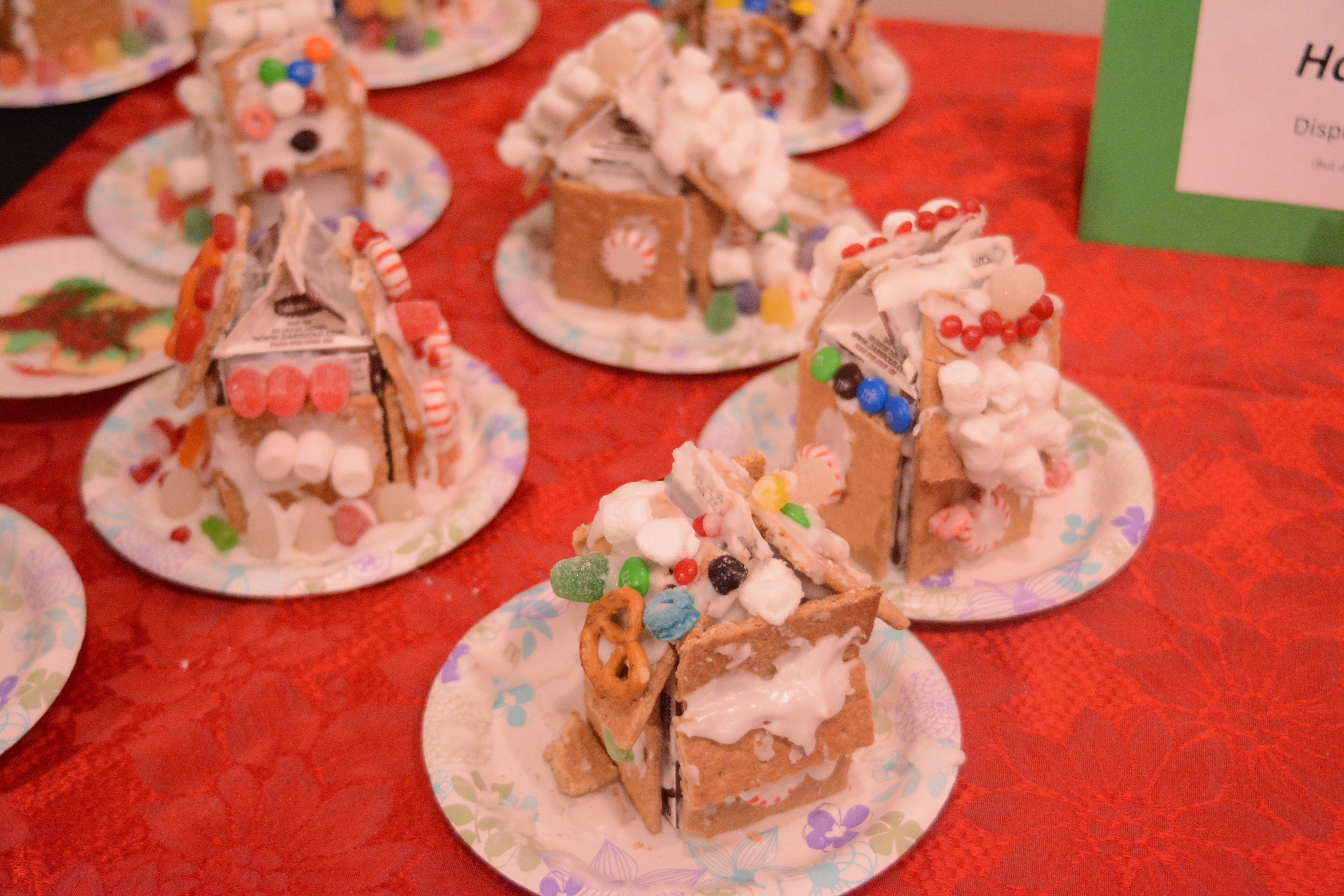 Completed graham-cracker houses are on display. The  Pratt Museum's annual event also included a visit from Santa Claus in the museum's historic Harrington Cabin.-Photo by Michael Armstrong, Homer News